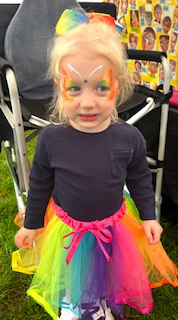 girl with rainbow butterfly face painting